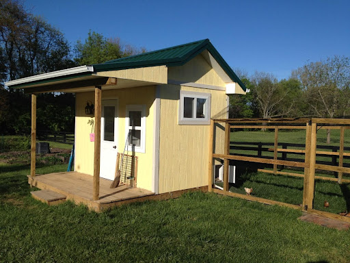 shed and porch next to a fence