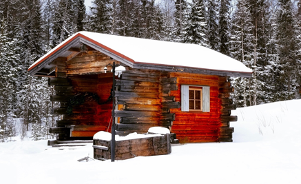 A wooden shed building amongst the snow